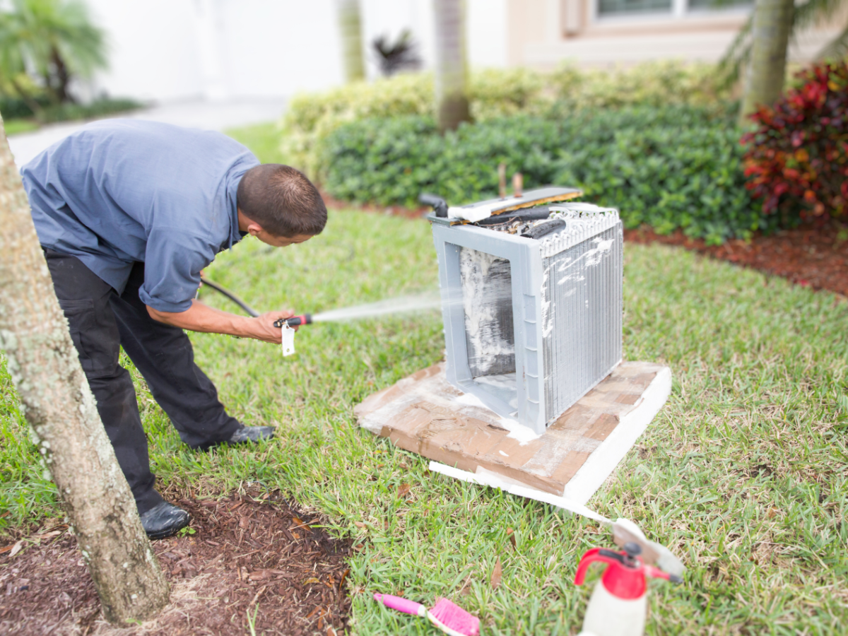 HVAC tech cleaning evaporator coils