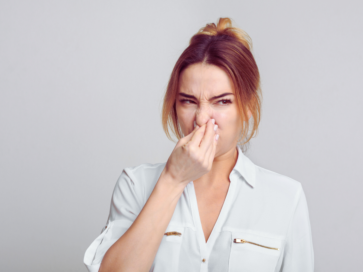 homeowner holding nose from bad heater smells