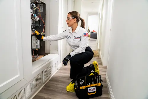 One Hour AC Tech, Denise, working Inside of a Furnace in a Jacksonville FL home