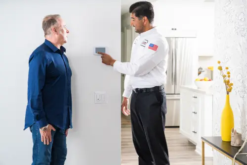One Hour AC Technician explaining how a smart thermostat works to a homeowner in Jacksonville FL