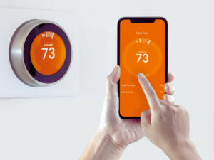 homeowner controlling smart thermostat