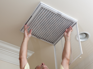 homeowner replacing AC filter in Florida home