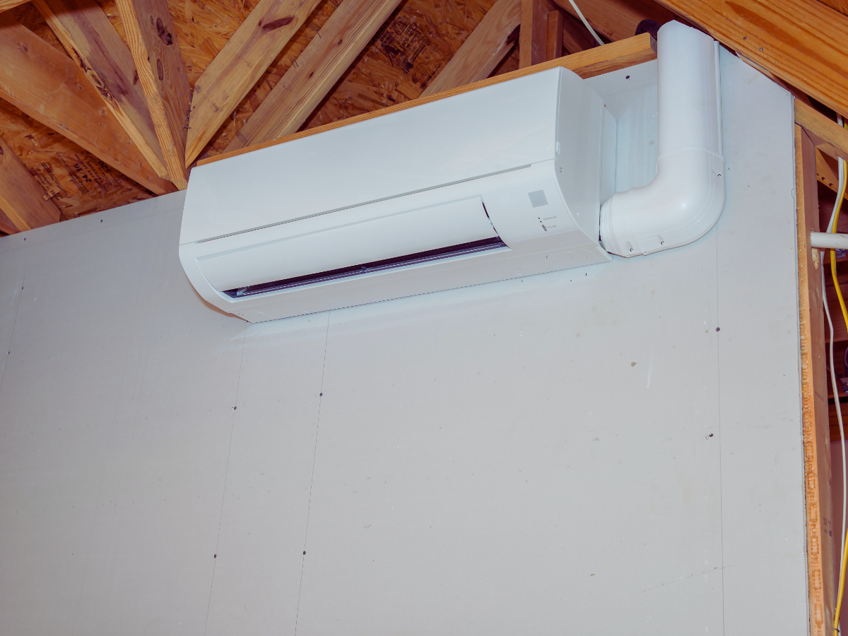 mini split ductless ac system placed high on living room wall for best airflow
